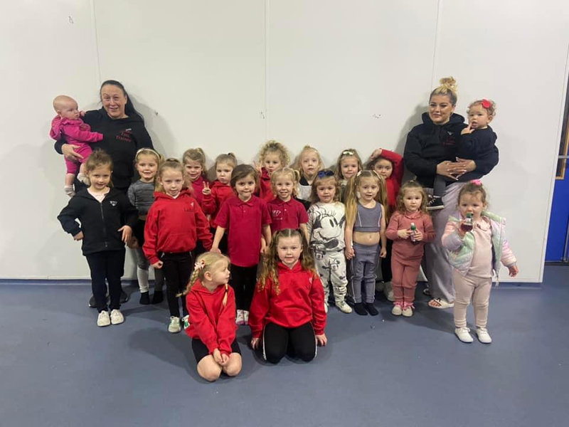 Young dancers and their teachers at a class in the hall